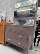 Load image into Gallery viewer, A stylish grey chest of drawers with contemporary design and solid construction. Features three spacious dovetail-jointed drawers offering reliable storage. Shows honest signs of use with minor surface marks, reflecting its pre-loved character. Structurally sound and ready for your home.

Delivery Available

Overall Dimensions

80cm wide x 40cm deep x 75cm high

