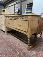 Load image into Gallery viewer, Authentic stripped oak hall table with natural patina and character. Features two deep dovetail-jointed drawers offering practical storage. This pre-loved piece shows honest wear including surface marks and a crack to one leg—but nothing that cannot be fixed. The bare wood finish invites personalisation with wax or oil to suit your décor.&nbsp;

Delivery Available

Overall Dimensions

137.5cm wide x 45cm deep x 88cm high

