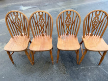 Load image into Gallery viewer, A charming set of four vintage wheelback dining chairs with solid structural integrity. Each chair is ready for your creative touch—ideal for refinishing, painting, or upcycling into statement pieces. Light cosmetic wear adds character and authenticity. Perfect for the DIY enthusiast or furniture restorer looking to bring these classics back to life.

Delivery Available

Overall Dimensions

approx : 38cm wide x 45.5cm deep x 90.5cm high

