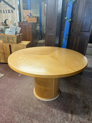 This Skovby dining table is equipped with a unique extension system. By turning the turntable under the tabletop the three leaves move synchronously to a position that makes room for the extension leaves in the base. When light pressure is applied the extension leaves unfold by means of a spring placed under the triangle in the middle of the table.The dining table can be extended from six to nine seatings. It is used and does have a few marks but nothing major at all.

Overall Dimensions

120cm diameter x 7
