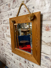 Load image into Gallery viewer, This sweet pine mirror is structrually sound and in overall good condition. It is used and does have some marks but nothing too major. It has a bit of rope for hanging.

Delivery Available

Overall Dimensions

38cm wide x 43.5cm high&nbsp; &nbsp;

