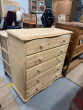 Load image into Gallery viewer, This solid pine chest features five spacious drawers offering generous storage for any bedroom. The stripped finish reveals the natural wood grain, creating warm, versatile tones that complement various décor styles. To maintain its appearance and protect the wood, application of wax is recommended. A practical, timeless piece that brings understated character to your space.

Delivery Available

Overall Dimensions

84cm wide x 38.5cm deep x 90.5cm high&nbsp;

