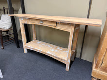 Load image into Gallery viewer, Discover the natural beauty of this stripped pine console table, revealing the wood's authentic grain and character. Featuring practical storage with a single drawer and lower shelf, it's perfect for entryways or living spaces. The bare wood finish offers flexibility—apply wax or your preferred finish to achieve your desired look and protect the surface.&nbsp;

Delivery Available

Overall Dimensions

151cm wide x 36cm deep x 76cm high

