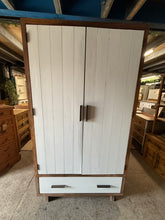 Load image into Gallery viewer, This charming two-tone wooden wardrobe is sturdy and generally well-preserved. While it has a few marks and a small missing piece on one side, these do not impact its functionality. It includes a hanging rail and a spacious drawer for storage, and it fully dismantles to make moving hassle-free.

Overall Dimensions

110cm wide x 63cm deep x 200cm high

DELIVERY AVAILABLE      

For our other items see our website https://fossewayfurniture.co.uk

collection from our shop at cv36, our collection zone at bs36 o
