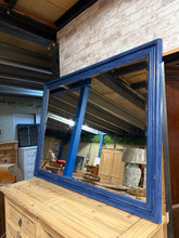 Load image into Gallery viewer, Discover character with this substantial pine mirror, featuring a classic bevelled edge. Structurally sound and ready for your personal touch, this piece invites creative refinishing—whether you prefer to restore its natural wood finish or apply a fresh coat of paint to match your décor. The solid construction and generous size make it a striking focal point for any room.

Delivery Available

Overall Dimensions

136cm wide x 107cm high

