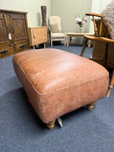 Load image into Gallery viewer, A versatile brown leather pouffe that combines practicality with timeless style. Structurally sound and built to last, this piece works beautifully as extra seating, a footrest, or a distinctive accent in any room. The natural patina of the leather adds character, while a gentle polish will refresh its appearance and restore its lustre.

Delivery Available

Overall Dimensions

75cm wide x 51cm deep x 36cm high&nbsp;

