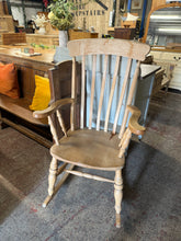 Load image into Gallery viewer, Crafted from solid pine, this charming rocking chair combines timeless appeal with practical comfort. Its sturdy construction ensures reliable everyday use, while the gentle rocking motion creates a soothing retreat. Bearing the character of age with minor surface marks, this piece brings authentic vintage warmth to any room—ideal beside a fireplace or as a peaceful reading nook companion.

Delivery Available

Overall Dimensions

approx measurements : 68cm wide x 84cm deep x 110cm high&nbsp;

