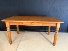 Load image into Gallery viewer, A timeless solid pine dining table built to last. This sturdy piece seats six comfortably and features a practical front drawer for storing table linens and dining essentials. The removable legs make transport and rearrangement effortless. Finished with natural character marks that add authentic charm to any dining space.

Delivery Available

Overall Dimensions

150cm long x 84cm wide x 76cm high

