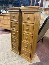 Load image into Gallery viewer, A charming pair of pine cupboards, each featuring five decorative sham drawers and four internal shelves for practical storage. Versatile pieces that work beautifully as bedside tables, lamp stands, or plant displays. Pre-loved with gentle patina and minor surface marks that add to their character.

Delivery Available

Overall Dimensions

27cm wide x 21cm deep x 92cm high&nbsp;

