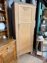Load image into Gallery viewer, This beautiful stripped oak wardrobe showcases the wood's natural grain and character. Returned to bare wood, it's ready for your chosen finish—a protective wax coat will enhance both appearance and durability. The piece features a practical hanging rail and hooks, ideal for organizing clothing and accessories. Minor marks add authentic vintage charm. A versatile addition to any bedroom, combining natural beauty with functional storage.

Delivery Available

Overall Dimensions

72cm wide x 44cm deep x 182.5c
