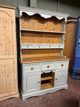 Load image into Gallery viewer, This charming solid pine dresser is painted a soft light blue by its previous owners and could use a little refresh in some spots. It offers plenty of storage, featuring 2 shelves and 4 drawers in the upper section, along with 3 drawers and 2 cupboards below. Plus, it splits into two parts to make moving simpler and more convenient.

Overall Dimensions

122cm wide x 44cm deep x 188cm high

DELIVERY AVAILABLE      

HAVE THIS PAINTED A COLOUR OF YOUR CHOICE FOR AN EXTRA £100 OR HAVE IT COMPLETELY STRIPPED BA
