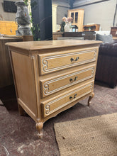 Load image into Gallery viewer, An elegant French Louis-style chest of drawers offering timeless sophistication. This structurally sound piece features three spacious long drawers, ideal for bedroom or living room storage. With characteristic period styling, it bears the gentle patina of age—minor surface marks that add authentic character. A versatile addition to classic or eclectic interiors.

Delivery Available

Overall Dimensions

80cm wide x 44.5cm deep x 77cm high

