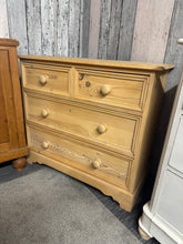 Load image into Gallery viewer, This solid pine chest of drawers showcases beautiful natural wood grain after being stripped back to bare wood. The classic configuration features two short dovetail-jointed drawers above two spacious long drawers, offering practical storage for any room. Structurally sound and in excellent condition, it's ready for finishing with wax or your choice of protective coating to enhance and preserve the timber. A timeless piece with authentic craftsmanship.

Delivery Available

Overall Dimensions

91cm wide x 35
