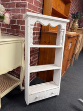 Load image into Gallery viewer, Charming white-painted pine shelving unit featuring two open shelves and two dovetail-jointed drawers for versatile storage. The piece is structurally sound, though the finish may show signs of age and could benefit from a light refresh or repaint to suit your décor. Wall fixings are not included but installation is straightforward. Perfect for adding character and function to any room.

Delivery Available

Overall Dimensions

46cm wide x 16cm deep x 94cm high

