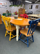 Load image into Gallery viewer, A charming solid pine oval dining table with authentic character. The sanded and varnished top pairs beautifully with cream-painted legs, creating a classic farmhouse aesthetic. Seats 4–6 comfortably, making it ideal for family gatherings and entertaining. The table shows gentle signs of age—a small crack to the top and minor touch-ups needed on the legs—adding to its rustic appeal. Structurally sound and built to last. Fixed legs for stability.

Delivery Available

Overall Dimensions

152cm long x 85cm wid
