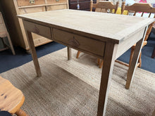 Load image into Gallery viewer, Characterful stripped oak table with authentic patina from years of use. The natural wood finish showcases the grain beautifully, though a protective wax coat is recommended. Features two dovetail-jointed drawers for practical storage. Surface wear and minor veneer lifting on the top add to its vintage charm and don't affect functionality.&nbsp;

Delivery Available

Overall Dimensions

106cm wide x 68cm deep x 75cm high

