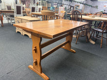 Load image into Gallery viewer, Crafted from pine, this versatile dining table seats 4–6 people comfortably, making it ideal for family meals and entertaining. The piece shows signs of use with minor surface marks that add character. Structurally sound and built to last, it brings warm, natural wood tones to any dining space.

Delivery Available

Overall Dimensions

122cm wide x 68cm deep x 73.5cm high

