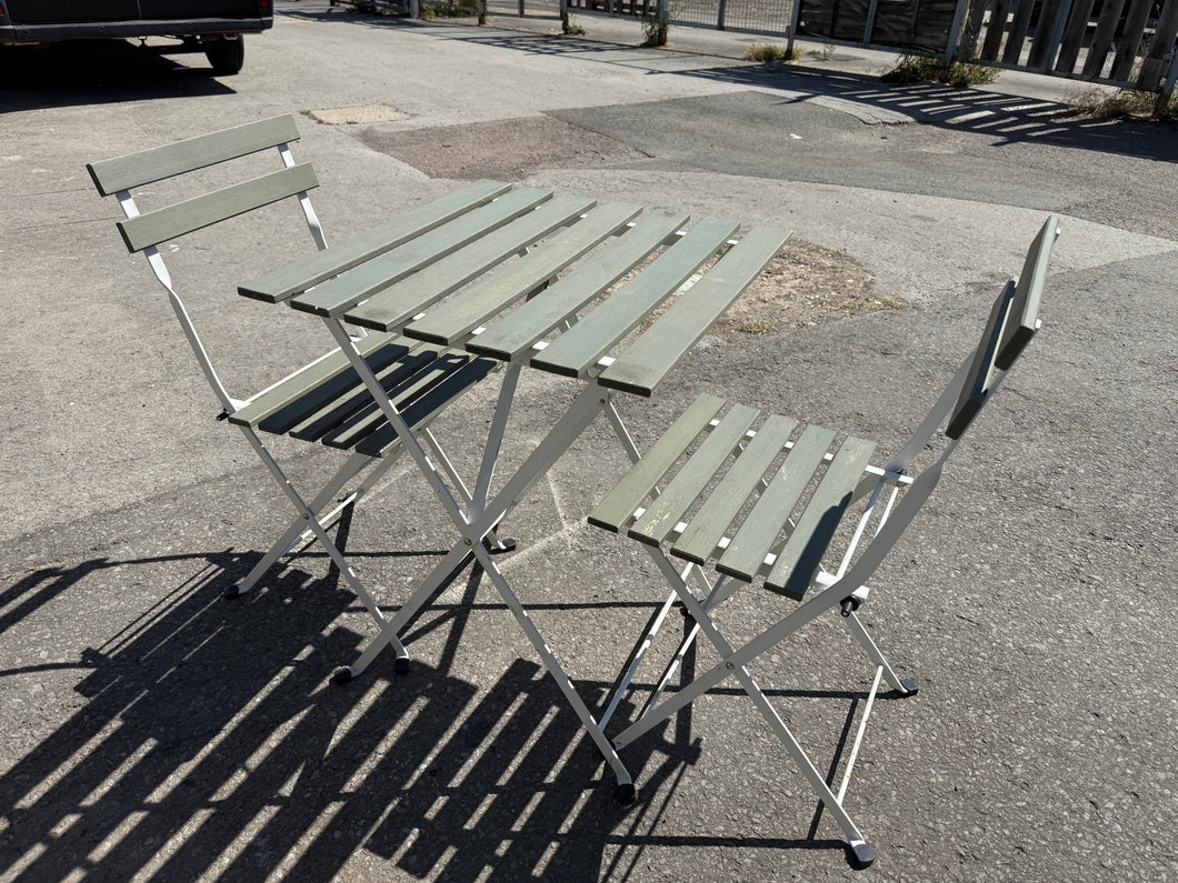 This delightful patio set in a lovely sage green is solid and in great condition. It has a few small signs of wear, but they don’t take away from its charm. The folding chairs and table make it easy to store, ideal for any outdoor area.

Delivery Available

Overall Dimensions

table dimensions: 54cm wide x 55cm deep x 71cm high  
