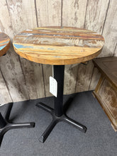 Load image into Gallery viewer, Discover this boat wood side table. Built to last, it combines structural integrity with genuine character. The surface showcases subtle signs of use. Perfect for those seeking a bar table inside or out.

Delivery Available

Overall Dimensions

50cm diameter x 77cm high&nbsp; &nbsp; &nbsp;

