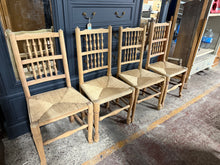 Load image into Gallery viewer, A charming quartet of authentic oak farmhouse chairs, lovingly restored to reveal their natural beauty. Each piece has been carefully stripped to showcase the wood&#39;s genuine character, ready for your finishing touches with wax. These pre-loved chairs bear the honest patina of age—subtle marks and minor seat wear that only add to their rustic appeal. Perfect for those seeking genuine vintage character with plenty of life left to give.

Overall Dimensions

approx : 49cm wide x 40cm deep x 98.5cm high

DELIVER
