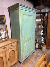 Load image into Gallery viewer, A charming period piece with character to spare, this vintage pine larder brings authentic charm to any home. The distinctive green-blue distressed finish tells a story of timeless appeal, whilst the robust construction promises years of reliable use. Inside, four adjustable shelves offer flexible storage solutions for linens, crockery, or treasured collections. Complete with its original key, this functional beauty combines practical storage with genuine vintage character that simply can't be replicated.


