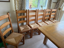 Load image into Gallery viewer, Set of 6 substantial oak dining chairs in good working order. Each chair shows natural patina and minor wear consistent with gentle use, adding rustic character. Ideal for country-style dining rooms and farmhouse interiors seeking authentic, durable seating with established charm.

Delivery Available

Overall Dimensions

approx : 44cm wide x 39cm deep x 110cm high&nbsp;

seat height 46cm

