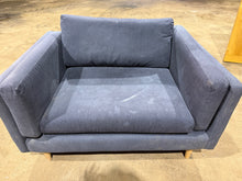 Load image into Gallery viewer, This navy cuddle sofa offers solid construction and reliable comfort for your living room. The frame is structurally sound, though the upholstery shows visible wear marks that can be significantly improved with professional cleaning. The detachable legs provide practical convenience for moving and repositioning. A straightforward choice for those seeking functional seating with good bones and honest value.

Delivery Available

Overall Dimensions

125cm wide x 94cm deep x 84cm to the top of the back cushion
