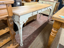 Load image into Gallery viewer, A charming mango wood hall table that brings character to your entryway. Featuring beautifully distressed legs that showcase authentic vintage appeal, paired with a smooth, clear waxed top that's easy to maintain. Two practical drawers provide convenient storage for keys, mail, and everyday essentials. Solidly constructed and in excellent condition, this piece combines timeless style with reliable functionality for a welcoming first impression.

Overall Dimensions

180cm wide x 51cm deep x 75cm high

DELIVE
