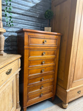 Load image into Gallery viewer, A handsome cherry wood tallboy with timeless appeal. This well-maintained piece features seven dovetail-jointed drawers offering generous storage. Structurally sound with minimal wear, it's an elegant addition to any bedroom or living space. A quality vintage find ready for a new home.

Delivery Available

Overall Dimensions

65cm wide x 40cm deep x 125.5cm high

