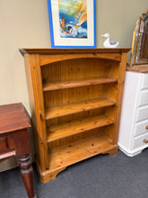 Load image into Gallery viewer, A charming pine bookcase with solid construction and three spacious shelves, perfect for displaying books and decorative items. The natural wood finish shows character and patina typical of pine furniture. Light surface marks can be easily restored with a gentle polish to reveal the wood's warm beauty. An ideal storage solution for any room.

Delivery Available

Overall Dimensions

99cm wide x 32cm deep x 120cm high

