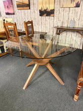 Load image into Gallery viewer, A stylish round glass dining table perfect for modern interiors. The removable glass top makes transport and cleaning effortless, whilst the sturdy base provides reliable everyday use. Shows minor wear consistent with pre-loved furniture. Comfortably seats four diners, ideal for smaller dining spaces or intimate gatherings.

Delivery Available

Overall Dimensions

120cm diameter x 74.5cm high

