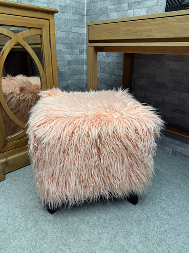 Discover the charm of this delightful pink sheepskin footstool. While there's minor wear to the underside fabric, it's completely hidden from view and won't impact performance or comfort. Perfect for adding a cosy, luxurious touch to any room!

Delivery Available

Overall Dimensions

48cm wide x 48cm deep x 46cm high  

