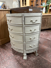 Load image into Gallery viewer, Elegant half-moon French style chest of drawers featuring solid construction and timeless appeal. Eight short dovetail-jointed drawers paired with four spacious long drawers provide ample storage for bedroom or living spaces. The carefully distressed finish adds vintage character and charm, making this piece a striking focal point in any room. Structurally sound and ready to enhance your home with classic French elegance.

Delivery Available

Overall Dimensions

67cm wide x 34cm deep x 76cm high

