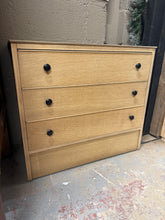 Load image into Gallery viewer, This oak veneer chest of drawers showcases its authentic grain in stripped-back condition. The piece is structurally robust with three spacious dovetail-jointed drawers offering reliable storage. While it bears the character marks of age, these are minor and add to its charm. A protective wax finish is recommended to enhance durability and bring out the wood's natural beauty.

Delivery Available

Overall Dimensions

76cm wide x 40cm deep x 67cm high

