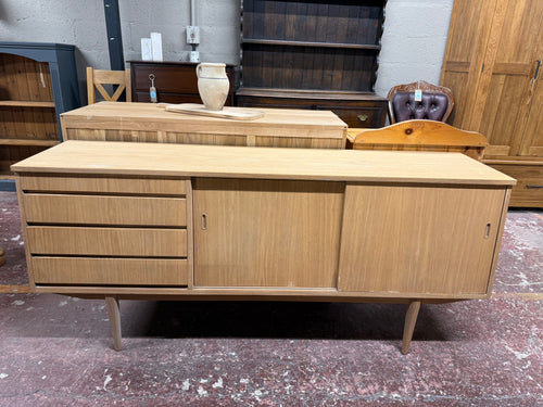 This beautiful teak sideboard has been fully restored to its original, natural finish. Minor marks where the veneer has slightly lifted enhance its unique character. It offers plenty of storage space with four spacious drawers and a double cupboard concealed behind a sliding door. It may benefit from a coat of wax for protection.

Overall Dimensions

182cm wide x 44cm deep x 80cm high

DELIVERY AVAILABLE      

For our other items see our website https://fossewayfurniture.co.uk

collection from our shop at 