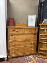 Load image into Gallery viewer, A classic solid pine chest of drawers built to last. Structurally sound with authentic character from years of use. Features two short dovetail-jointed drawers positioned above three spacious long drawers, offering generous storage for bedrooms or hallways. Minor cosmetic marks reflect its lived-in charm. Ideal for those seeking genuine craftsmanship and timeless design.

Delivery Available

Overall Dimensions

103cm wide x 45.5cm deep x 105cm + 12cm high

