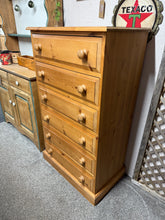 Load image into Gallery viewer, A substantial solid pine chest with six spacious drawers, each crafted with traditional dovetail joinery for durability. This piece shows honest signs of age and use—minor surface marks that enhance its character rather than detract from it. The frame remains solid and reliable, making it a dependable storage solution with genuine vintage appeal.

Delivery Available

Overall Dimensions

70cm wide x 43cm deep x 120cm high&nbsp;
