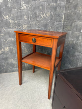 Load image into Gallery viewer, An elegant cherry wood side table combining timeless design with practical storage. Featuring a dovetail-jointed drawer and lower shelf, this piece offers both style and functionality. Structurally sound and in excellent condition, it's an ideal addition to period homes and traditional interiors seeking authentic craftsmanship and character.

Delivery Available

Overall Dimensions

39.5cm wide x 32cm deep x 61cm high

