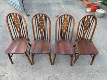 Load image into Gallery viewer, A charming set of four vintage wheelback dining chairs with authentic character. Each chair is structurally sound and ready for everyday use, featuring the patina and wear marks typical of well-loved period pieces. Light polishing will refresh the finish and enhance their natural beauty. Perfect for adding classic elegance to your dining space with timeless appeal and genuine vintage charm.

Delivery Available

Overall Dimensions

approx : 37.5cm wide x 46cm deep x 97cm high

