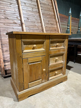 Load image into Gallery viewer, A sturdy pine sideboard offering practical storage with four short drawers and one enclosed cupboard. While the piece shows signs of use with surface marks, these&nbsp; can be easily refreshed with wax or polish. Solidly constructed and ready for everyday use.

Delivery Available

Overall Dimensions

92cm wide x 44cm deep x 84cm high&nbsp;

