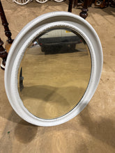 Load image into Gallery viewer, A charming oval mirror with bevelled edges in white and grey tones. This piece is structurally solid and ready to use, though it bears the gentle patina of age with minor surface chips that add character rather than compromise its appeal.&nbsp;

Delivery Available

Overall Dimensions

62cm wide x 82cm high

