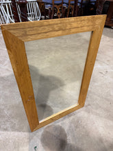 Load image into Gallery viewer, A oak-effect mirror with solid construction, ideal for up-cycling projects. This pre-loved piece bears the honest marks of use. Perfect for those seeking budget-friendly furniture with potential.

Delivery Available

Overall Dimensions

51cm wide x 76cm high

