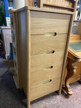 Load image into Gallery viewer, This sweet oak tallboy is structurally sound and in overall good condition. It does have a few small marks i.e 2 screw holes to one side but nothing major at all. It has 5 deep drawers for storage

Overall Dimensions

53cm wide x 38cm deep x 110cm high 

DELIVERY AVAILABLE    

For our other items see our website https://fossewayfurniture.co.uk

collection from cv36 or bs36

