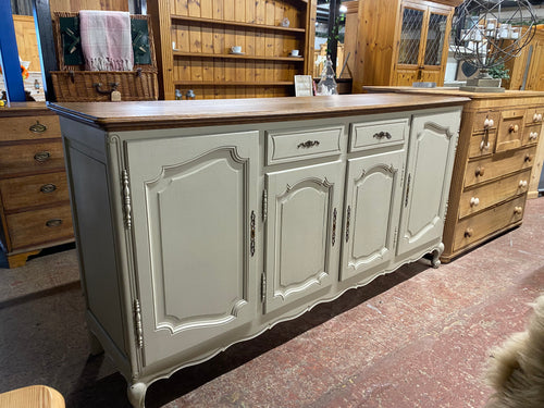 This stunning large oak sideboard is structurally sound and in overall good condition. Unfortunately there is one large scratch to the top but this can be sanded out. There are a couple paint chips to one side but this can easily be sorted. it is currently painted in a grey / green colour. It has ample storage with 2 short drawers and 4 cupboards.

Overall Dimensions

201.5cm wide x 53cm deep x 104cm high

DELIVERY AVAILABLE    

HAVE THIS PAINTED A COLOUR OF YOUR CHOICE FOR AN EXTRA £80 OR COMPLETELY STRIP