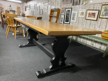 Load image into Gallery viewer, This stunning large oak dining table is structurally sound and in great condition. It does have a few marks but nothing major at all. The base has been painted in a deep black and may need a touch up in some areas. This table can seat up to 8 people. The top does come away from the base for easier moving.

Overall Dimensions

198.5cm long x 90cm wide x 76cm high

DELIVERY AVAILABLE    

For our other items see our website https://fossewayfurniture.co.uk

collection from cv36 or bs36

