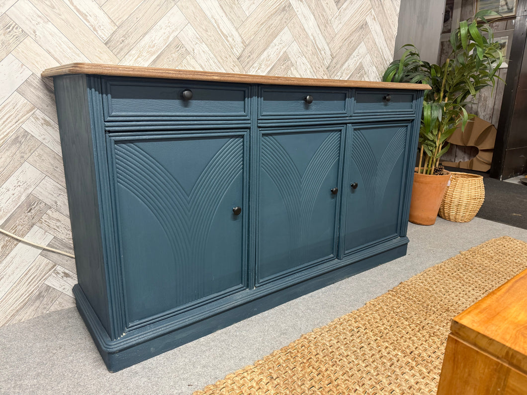 This gorgeous art deco style sideboard has been painted in a deep blue with the top sanded and waxed. It is structurally sound and In overall good condition. It was painted pink by previous owners and some of this does exist on the drawer sides etc still. It has ample storage with 3 short drawers over 1 double and 1 single cupboard.

Overall Dimensions

149.5cm wide x 43.5cm deep x 82cm high

DELIVERY AVAILABLE    

For our other items see our website https://fossewayfurniture.co.uk

collection from cv36 or