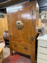 Load image into Gallery viewer, This durable, oriental-inspired wardrobe boasts a sturdy, solid wood construction and is in great condition overall. While there are some minor markings due to previous use, it is still very well-maintained. It features one hanging rail and a removable, adjustable shelf inside, as well as a discreetly placed hole in the back for wires (this was put in by previous owners). One of the legs has a small amount of damage, but it does not impact functionality.

Overall Dimensions

115cm wide x 58cm deep x 207cm h
