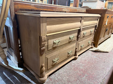 Load image into Gallery viewer, A striking mahogany chest of drawers, stripped to reveal its natural grain and warm patina. Six spacious dovetail-jointed drawers offer generous storage with smooth operation. Recently restored to excellent condition with only minor surface marks that add character. The bare wood finish showcases the timber's beauty—a light wax coat will enhance protection and lustre. A timeless statement piece that brings warmth and craftsmanship to any bedroom or living space.

Delivery Available

Overall Dimensions

150c
