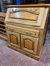 Load image into Gallery viewer, This durable, pine bureau is in excellent structural condition and offers plenty of storage with a drop-down writing desk above one long drawer, and a double cupboard.  Overall Dimensions  94cm wide x 45cm deep x 110cm high        DELIVERY AVAILABLE      For our other items see our website https://fossewayfurniture.co.uk 
