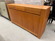 Load image into Gallery viewer, This John Lewis Henry sideboard combines practical storage with contemporary style. Structurally sound and in excellent condition, it features three short drawers above a single and double cupboard, each with internal shelving for organised storage. Minor marks reflect its pre-loved character. Ideal for modern interiors seeking quality furniture with timeless appeal.

Delivery Available

Overall Dimensions

139cm wide x 41cm deep x 81cm high


